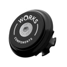 A upper bearing cover and Works Components branded top-cap in shiny anodised black with a black seal designed to work with all our angle and reach headsets.