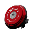 A upper bearing cover and Works Components branded top-cap in shiny anodised red with a black seal designed to work with all our angle and reach headsets.