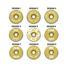 A headset top-cap in shiny anodised gold with multiple different written designs